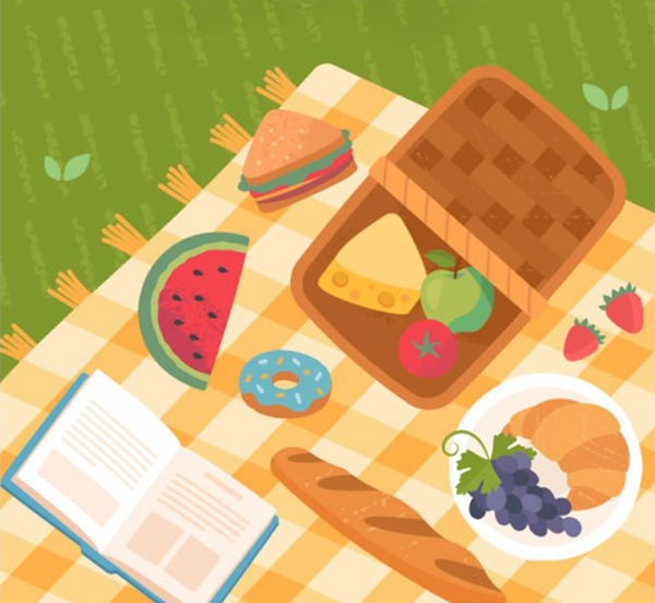 Picnic basket and food on a lawn