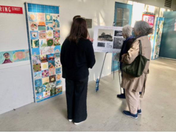 Neighbors view images at Grant Elementary school's community meeting on March 10, 2022
