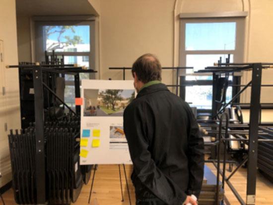 Man looking at board with McKinley Elemetary school plans