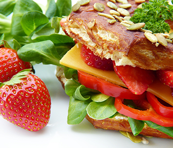 a healthy sandwich and strawberries