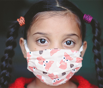 child wearing a mask to protect against Covid